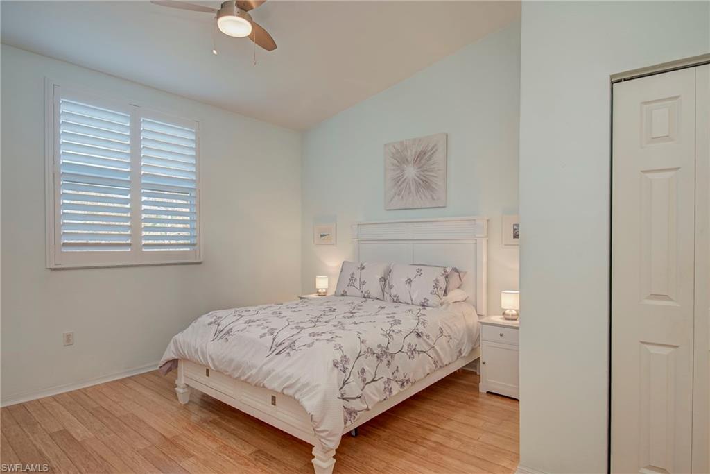 Bedroom featuring light wood-style floors, vaulted ceiling, and ceiling fan