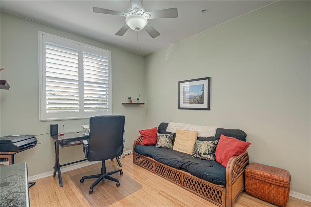 Office space with light wood-style flooring and a ceiling fan