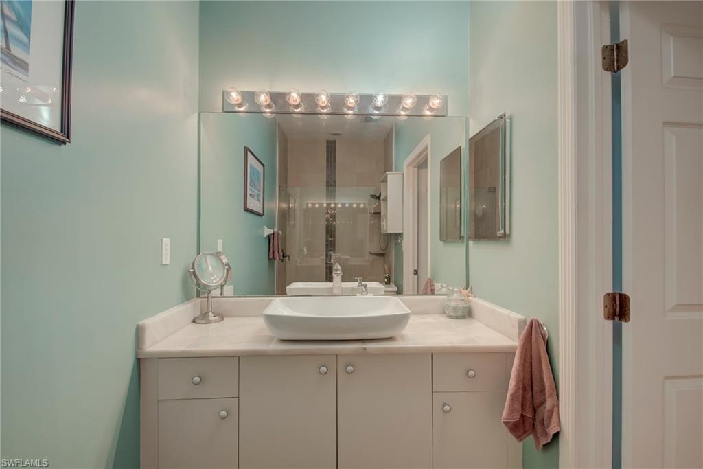 Bathroom featuring vanity and a stall shower
