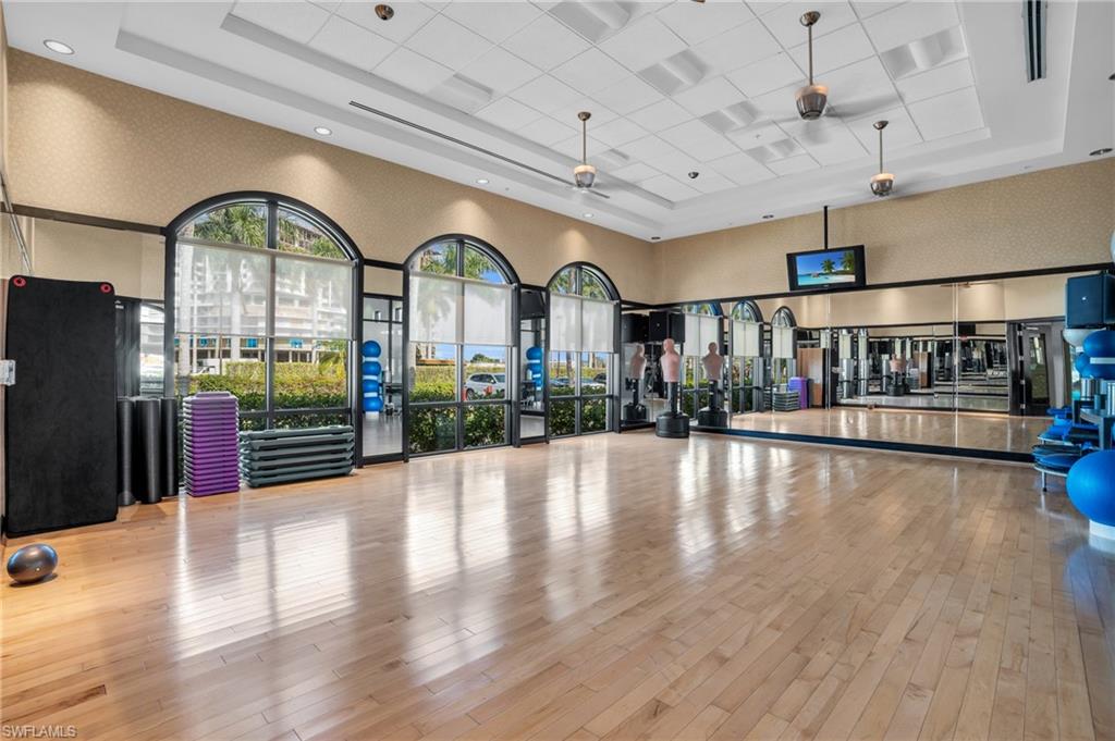 Workout area featuring a high ceiling and wallpapered walls