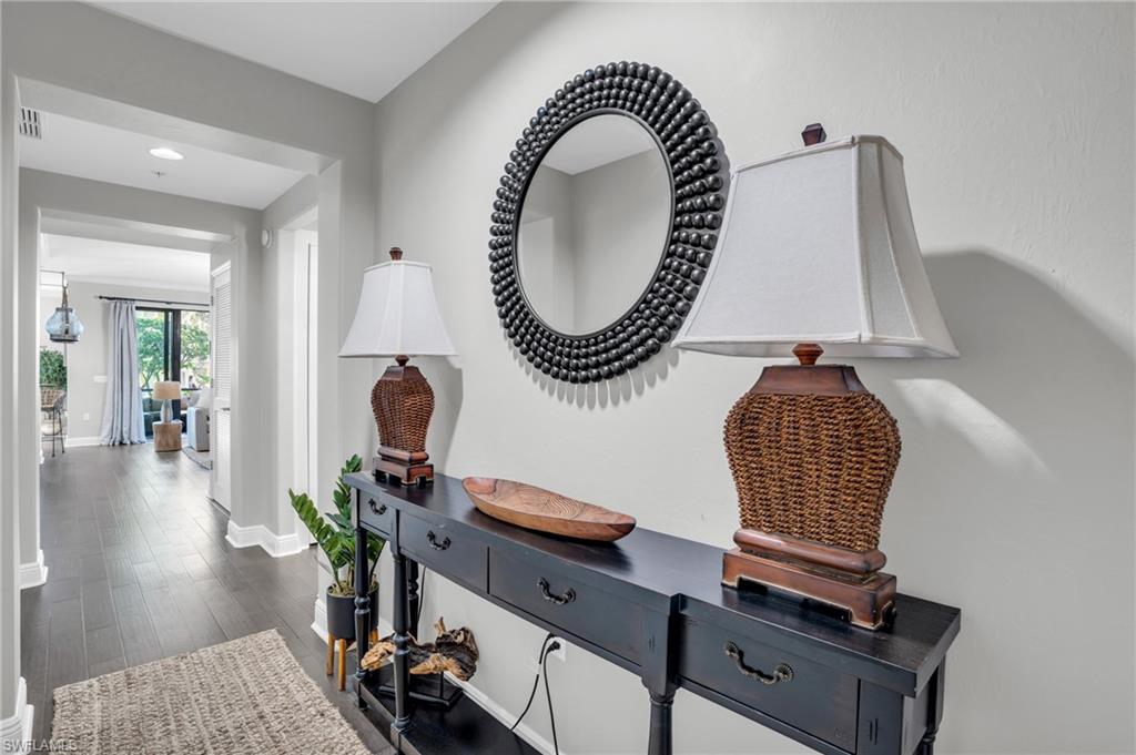 Corridor featuring dark wood finished floors and baseboards