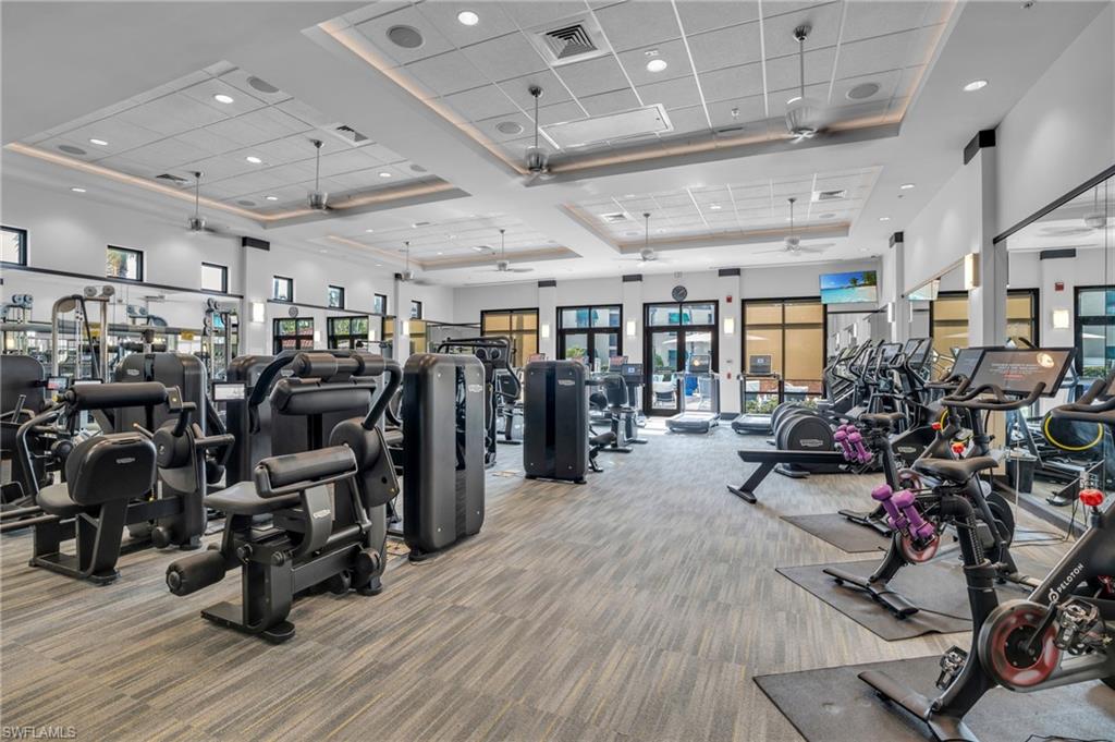 Exercise room featuring a high ceiling and recessed lighting