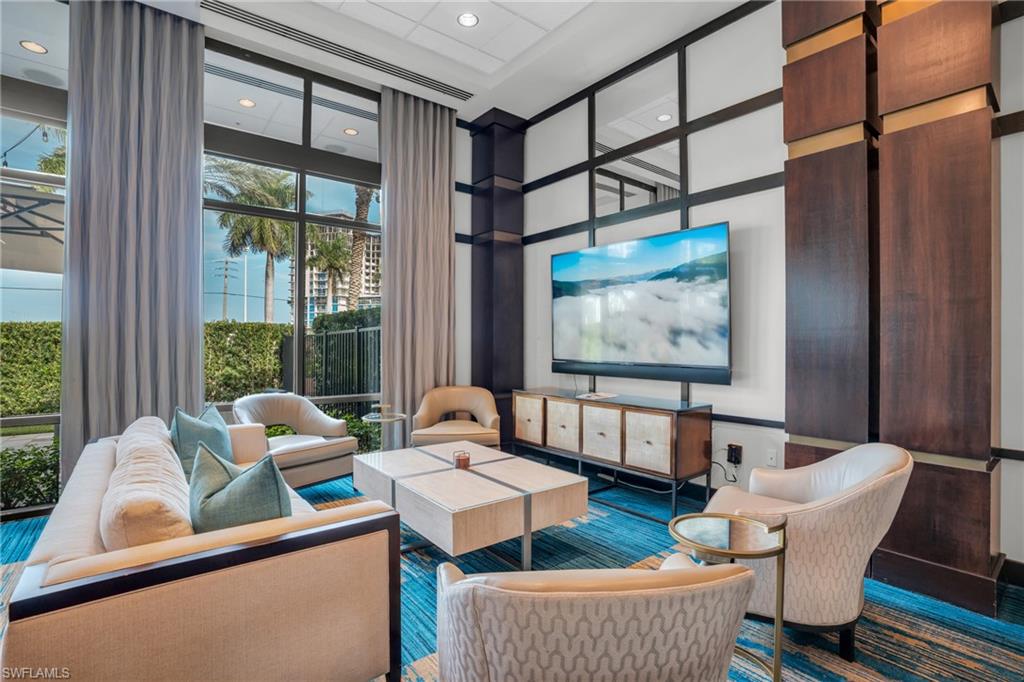 Community lobby with floor to ceiling windows and recessed lighting