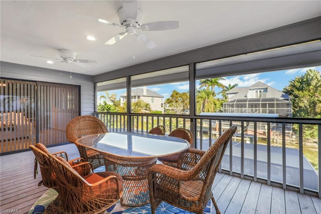 Sunroom / solarium featuring hardwood / wood-style flooring and recessed lighting