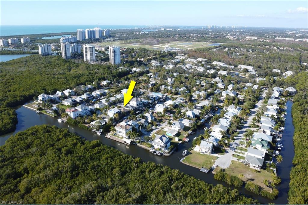 Aerial overview of property's location with a large body of water and nearby suburban area