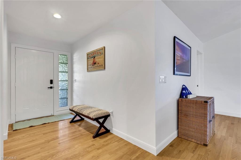 Foyer featuring light wood-type flooring and recessed lighting