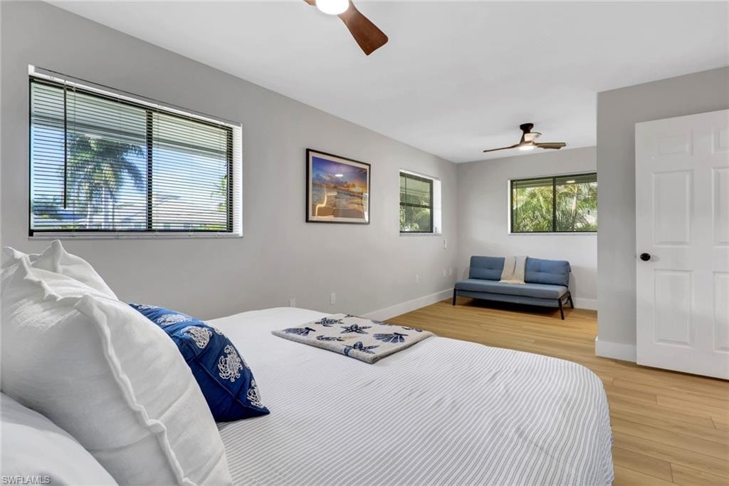 Bedroom 2 with light wood-style floors and a ceiling fan