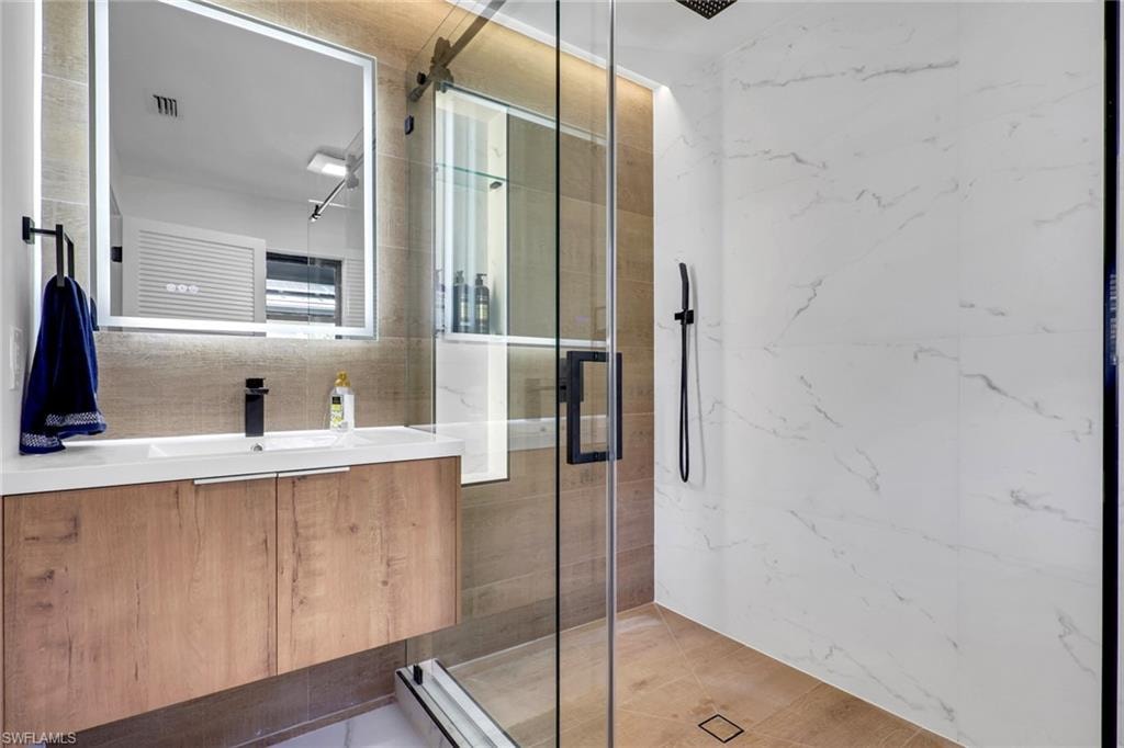 Bathroom 1- Full bath with vanity and a marble finish shower