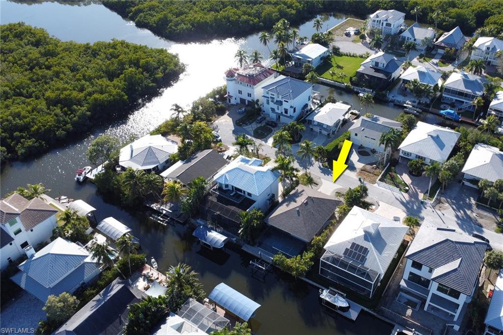 Aerial view of property's location featuring a large body of water and nearby suburban area