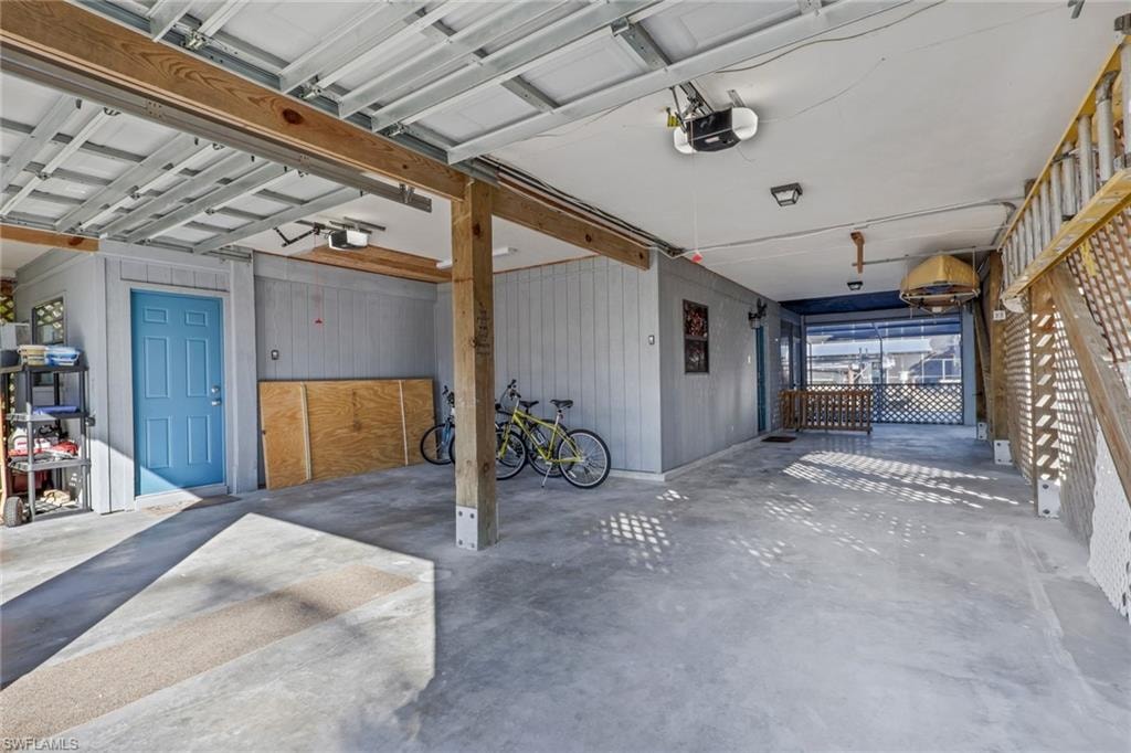 Garage with wooden walls and a garage door opener