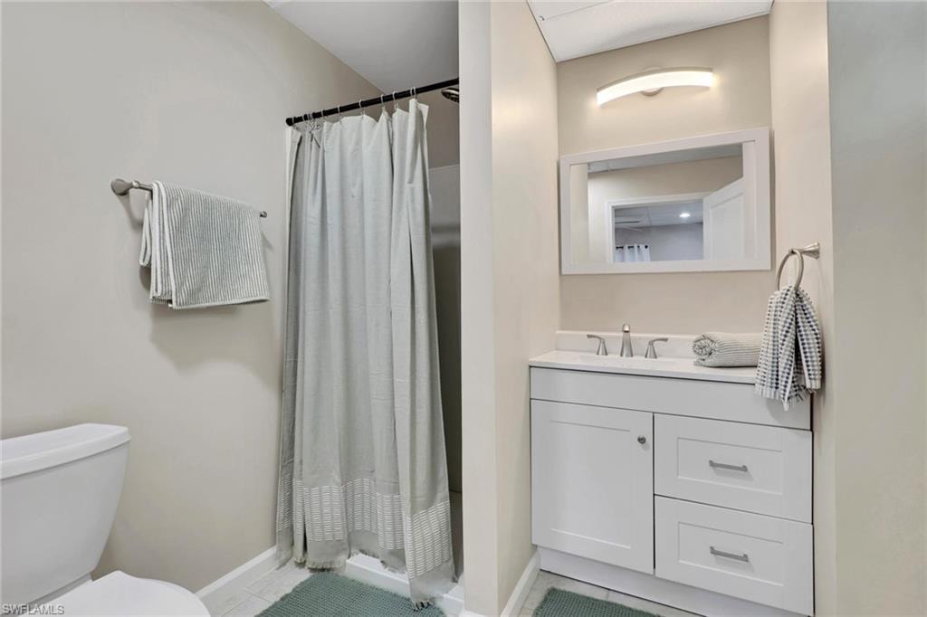 1/1 Efficiency-Bathroom with vanity and a shower stall