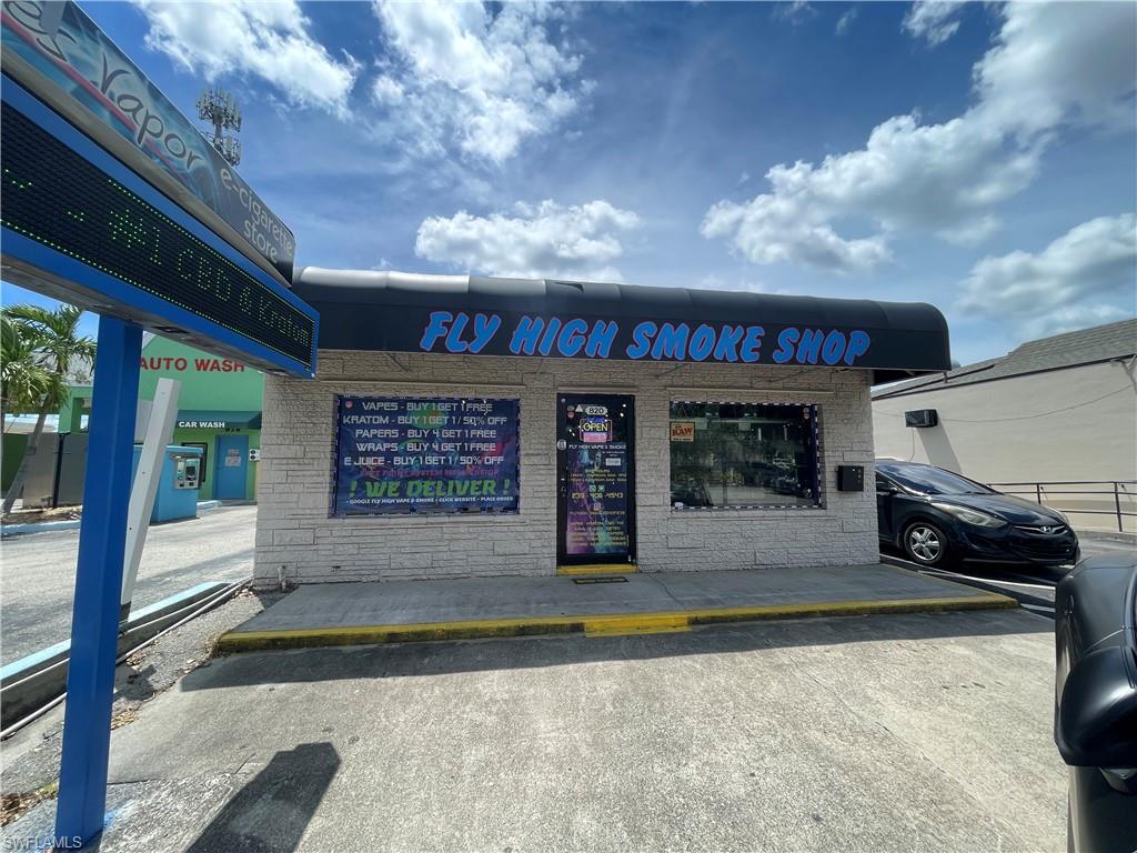 View of commercial property featuring uncovered parking
