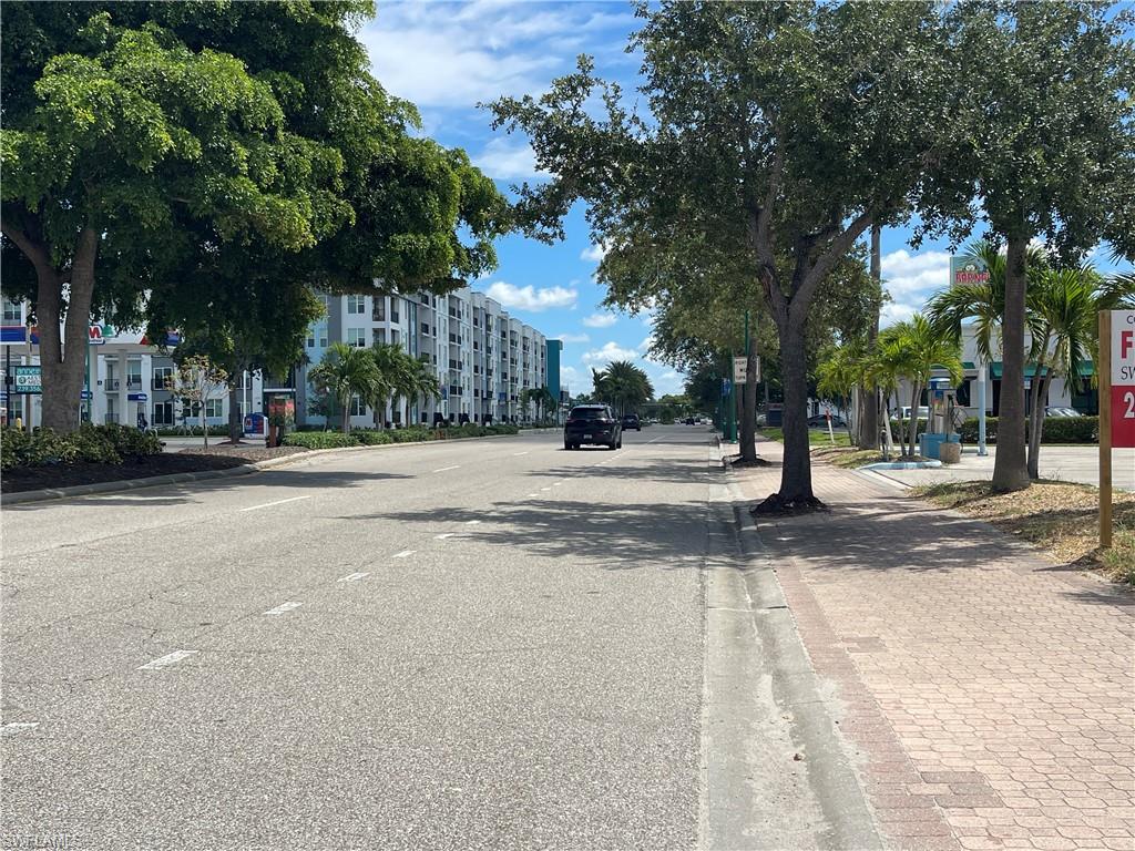 View of asphalt road with curbs and sidewalks