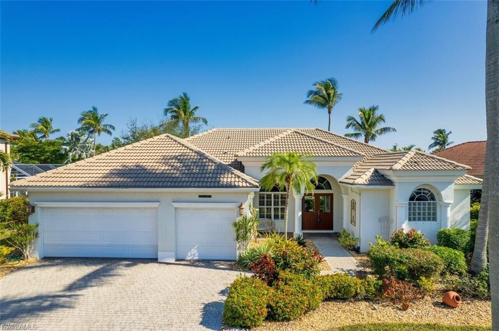 Mediterranean / spanish home featuring stucco siding, an attached garage, decorative driveway, a tile roof, and french doors