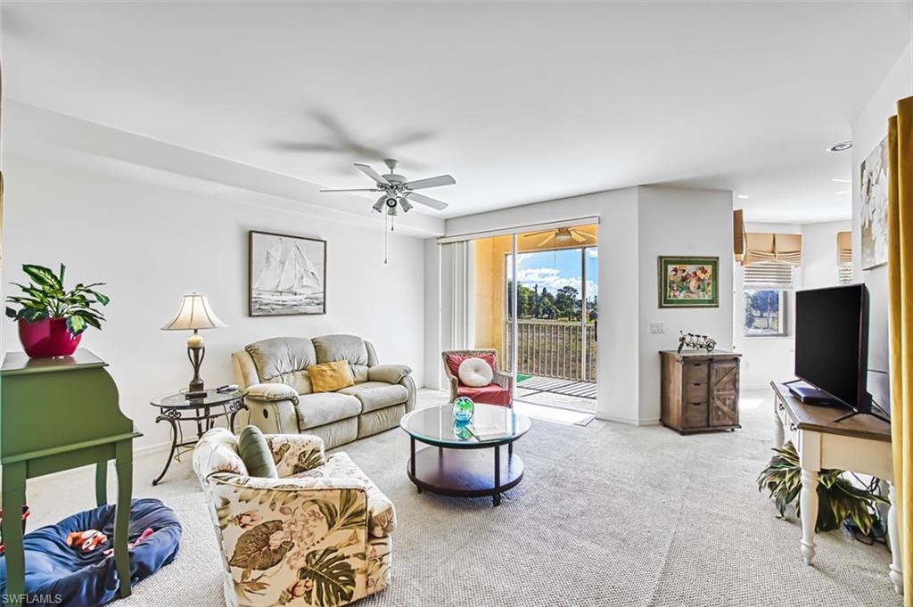 Living area with carpet and ceiling fan