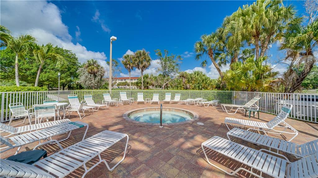View of swimming pool featuring a swimming pool, patio surround, and a hot tub