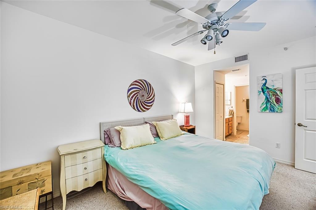 Bedroom with ensuite bathroom and a ceiling fan