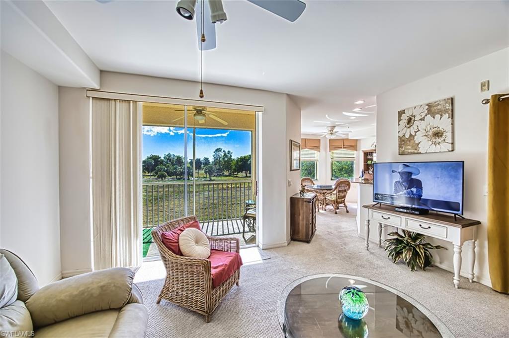 Living area with carpet and a sunroom