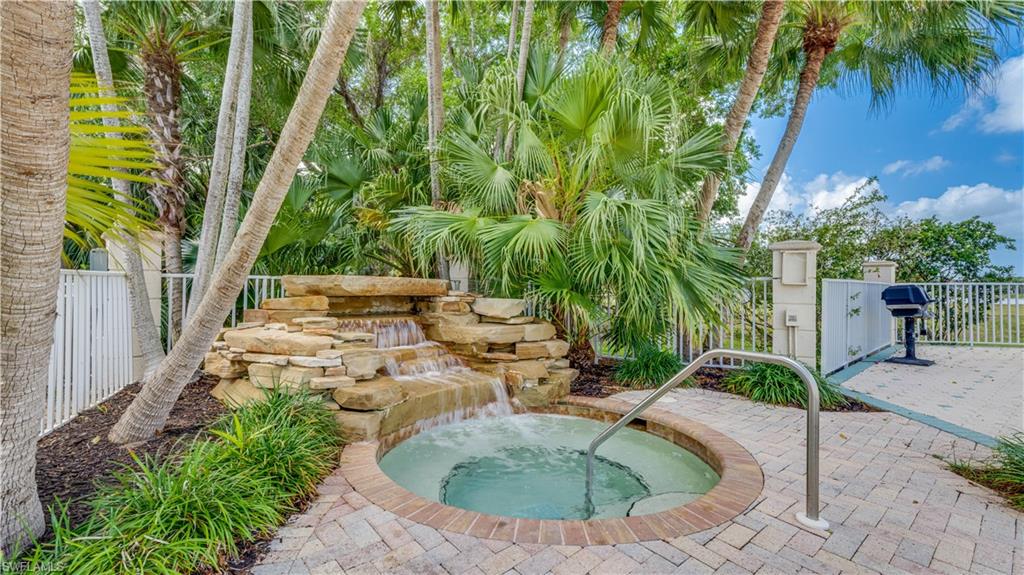 View of pool featuring a hot tub and patio surround