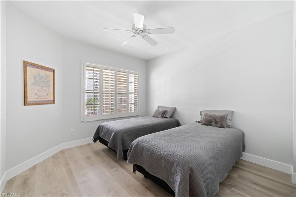 Bedroom with light wood-type flooring and a ceiling fan
