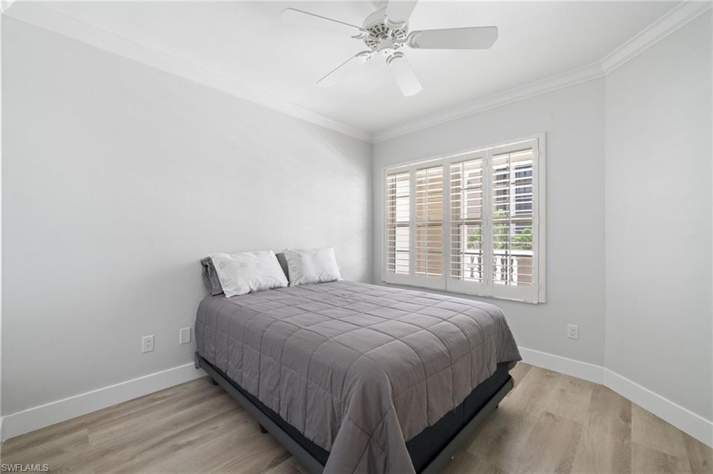 Bedroom featuring ornamental molding, light wood finished floors, and ceiling fan