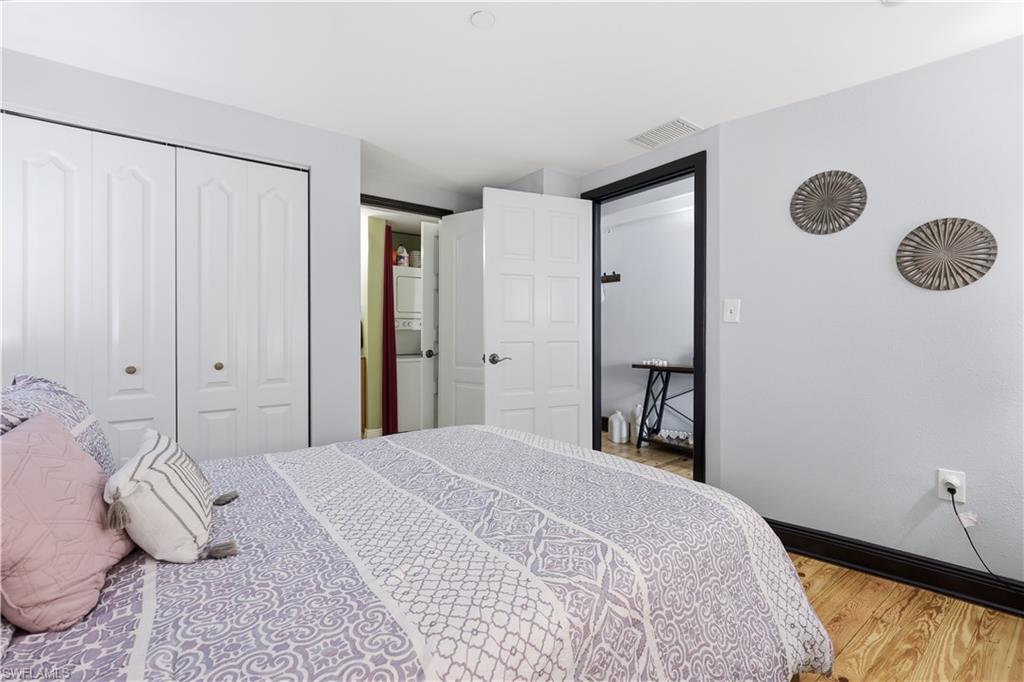 Guest Suite featuring stacked washer / dryer, a closet, and light wood-type flooring