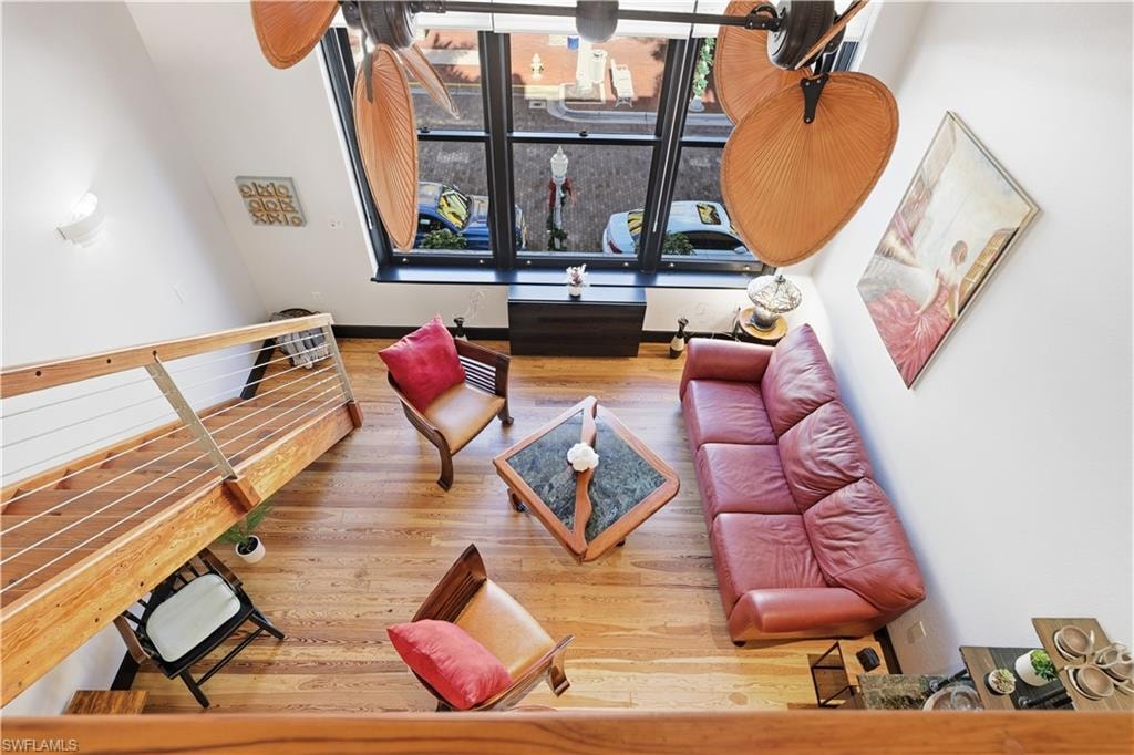 Upstairs view from the loft/den with light wood-style flooring