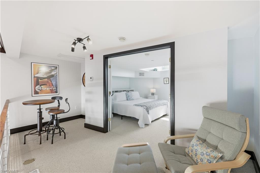 Upstairs Master Bedroom featuring light colored carpet and baseboards
