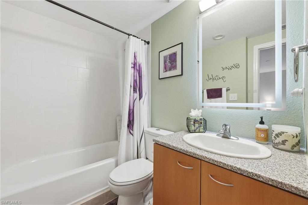 Guest Bathroom with shower / bathtub combination with vanity