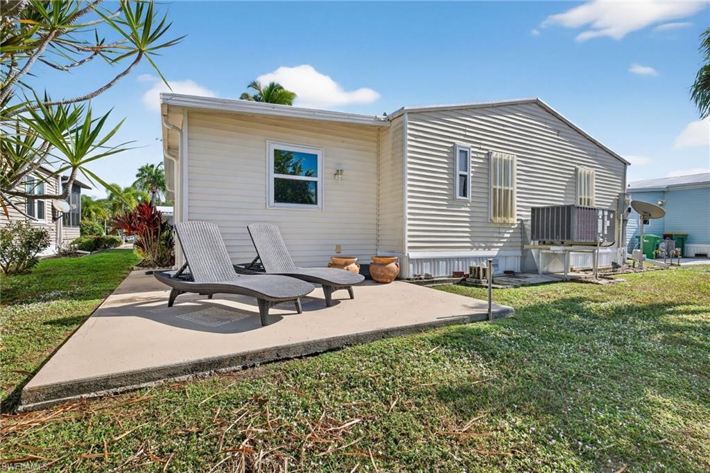 Rear view of house featuring a patio and a yard