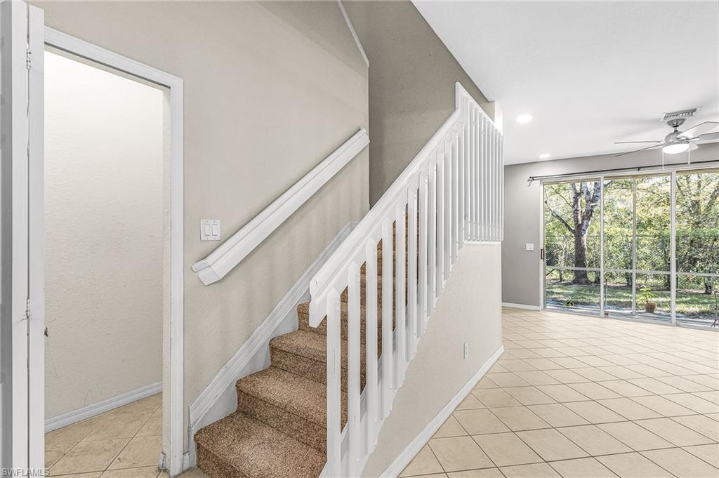 Staircase with tile patterned flooring, ceiling fan, and recessed lighting