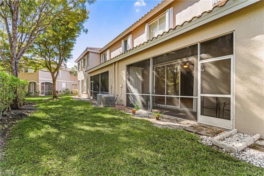 View of green lawn featuring a sunroom