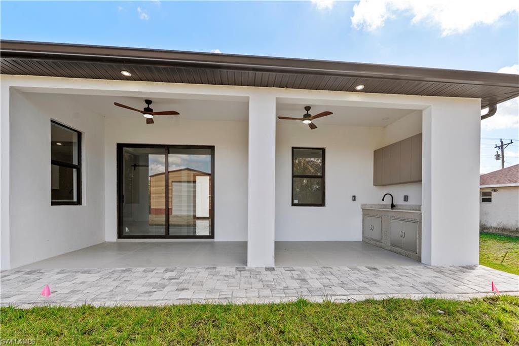 View of patio / terrace featuring a ceiling fan and an outdoor kitchen