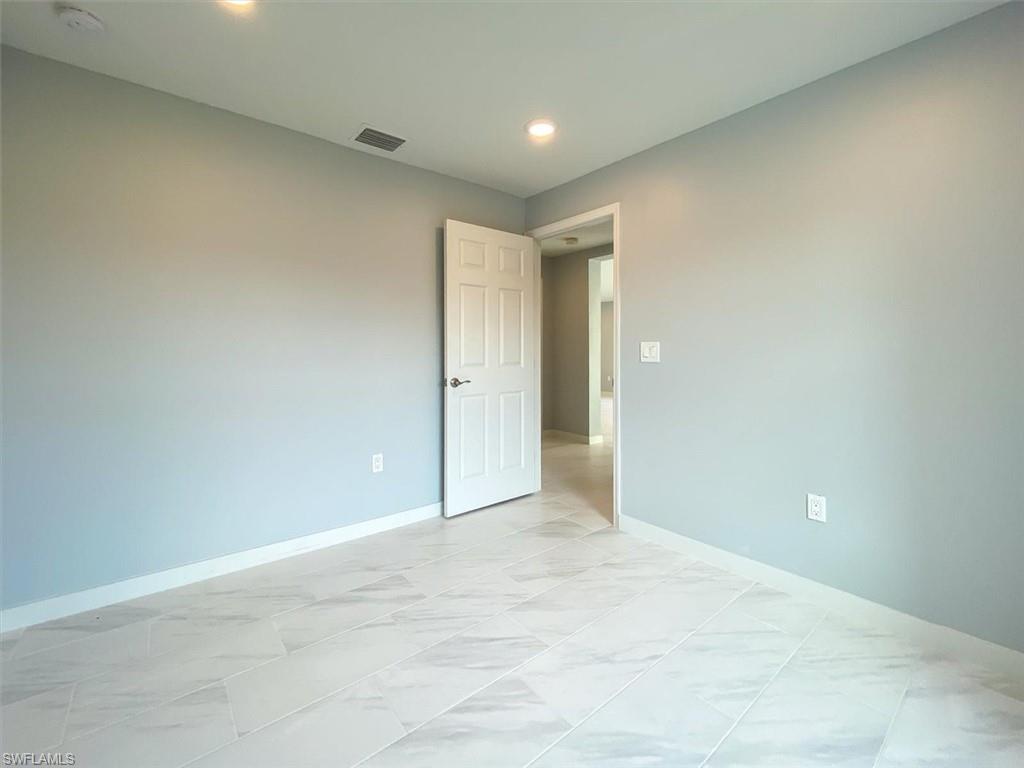 Empty room featuring recessed lighting and light marble finish flooring
