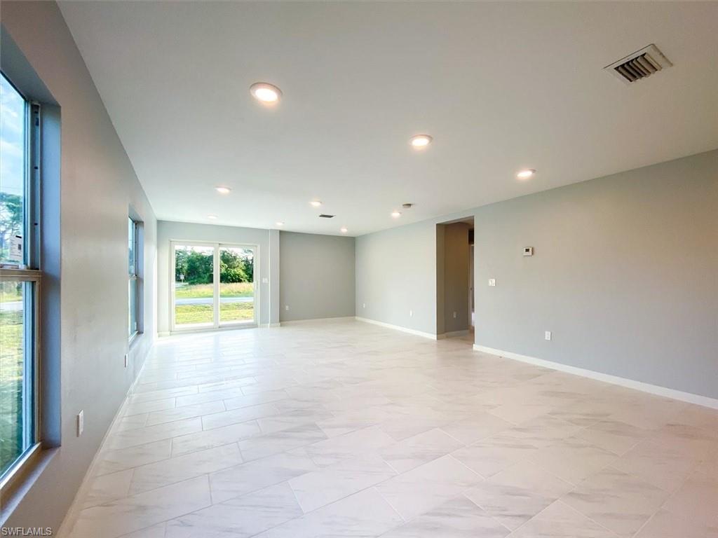Spare room featuring recessed lighting and baseboards