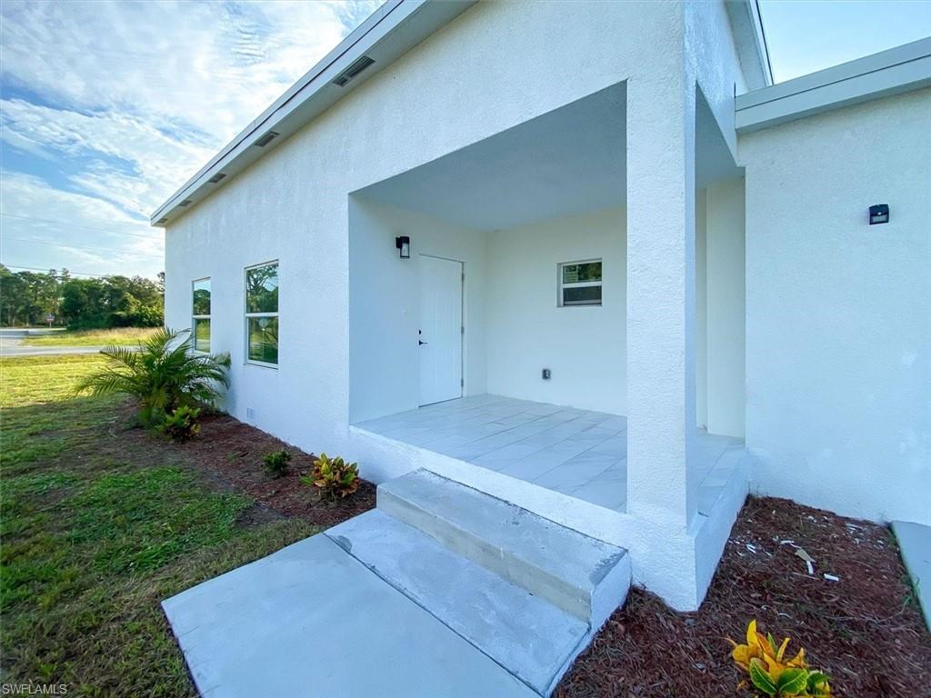 Property entrance with stucco siding