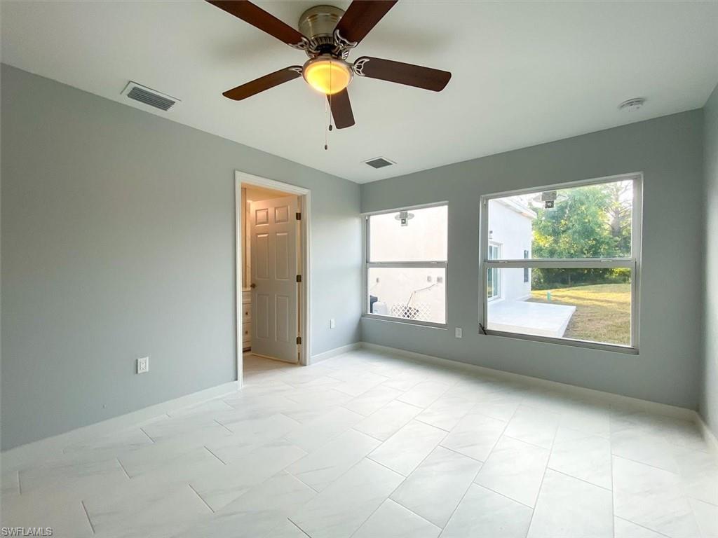 Unfurnished room featuring a ceiling fan and baseboards