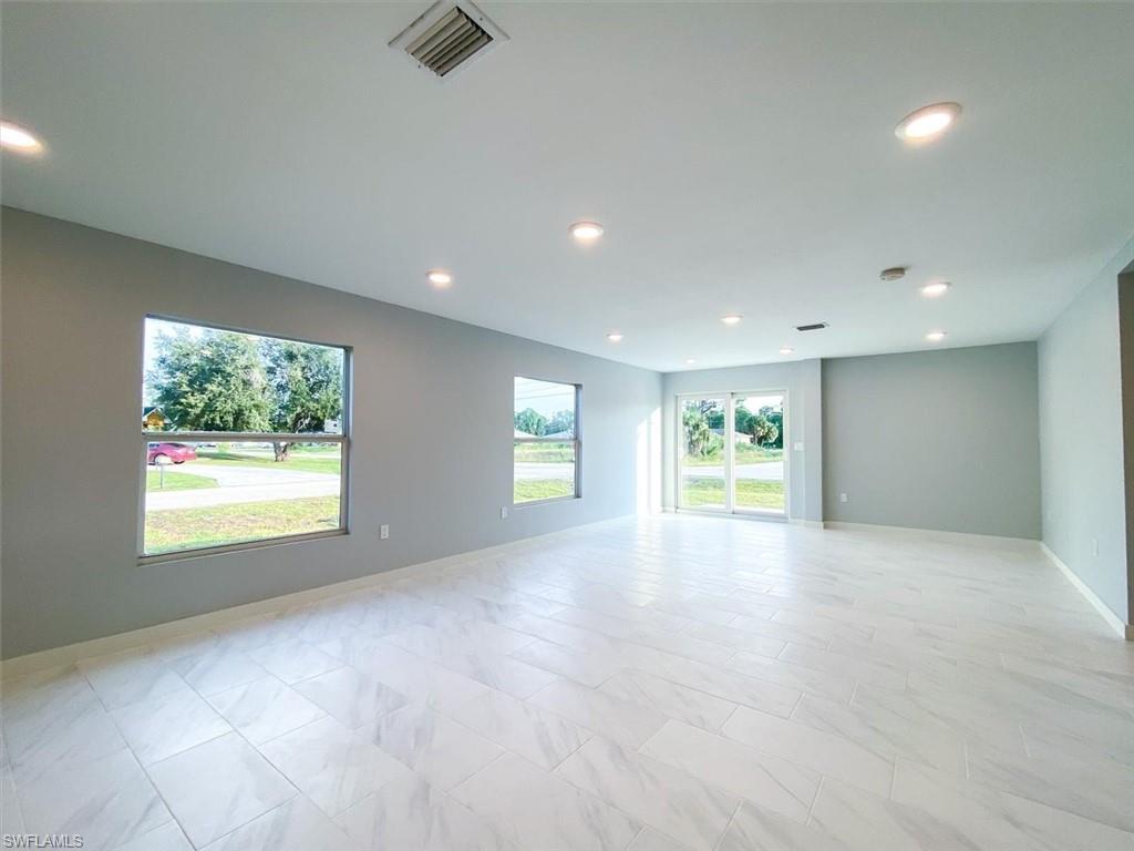 Unfurnished room with baseboards and recessed lighting