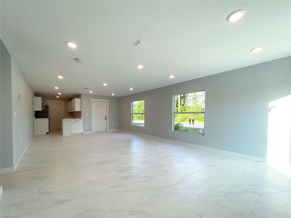 Unfurnished living room with baseboards and recessed lighting