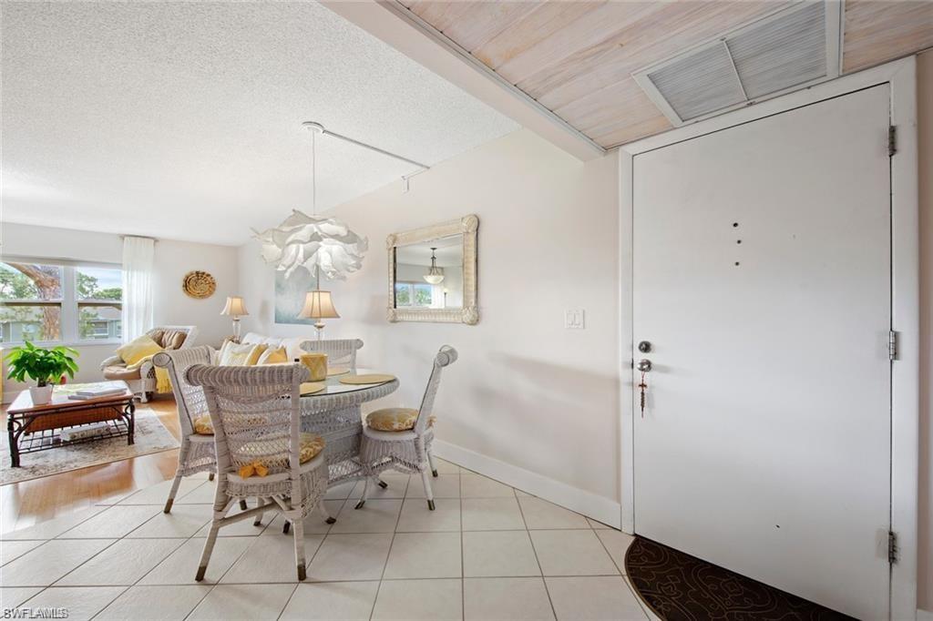 Dining space featuring healthy amount of natural light, light tile patterned floors, and a textured ceiling