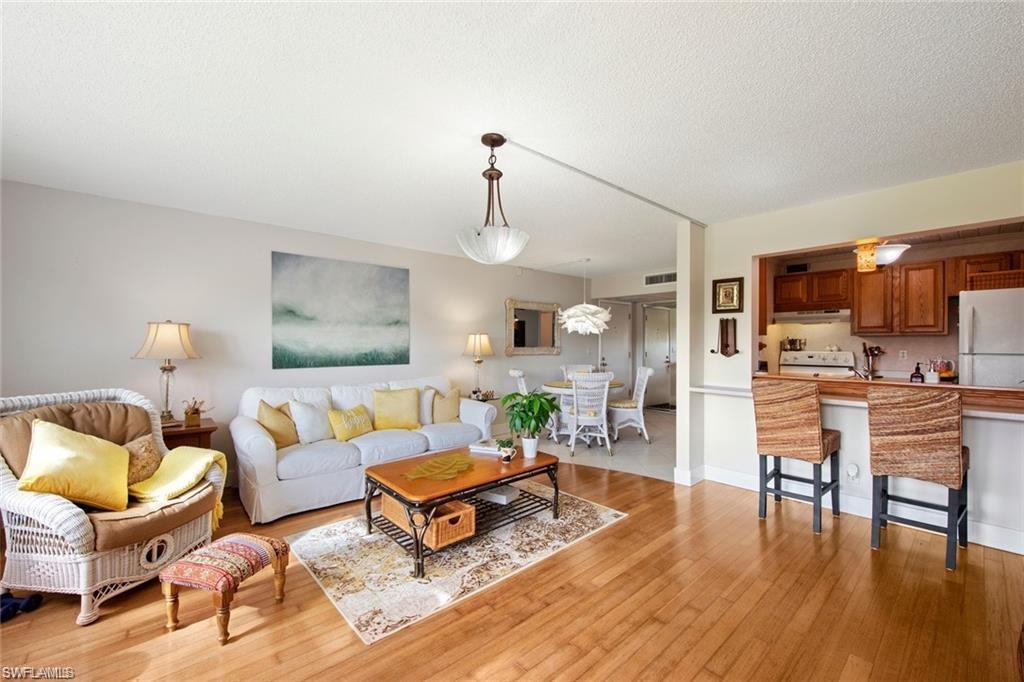 Living area with light wood-style flooring and a textured ceiling