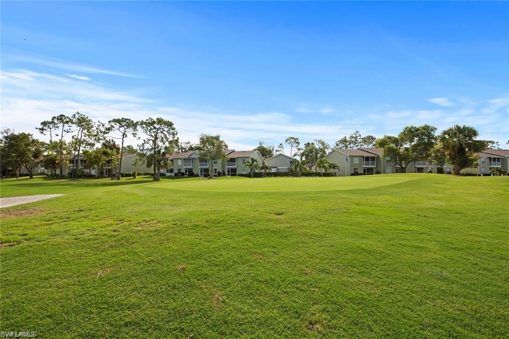 View of grassy yard with a residential view and view of golf course