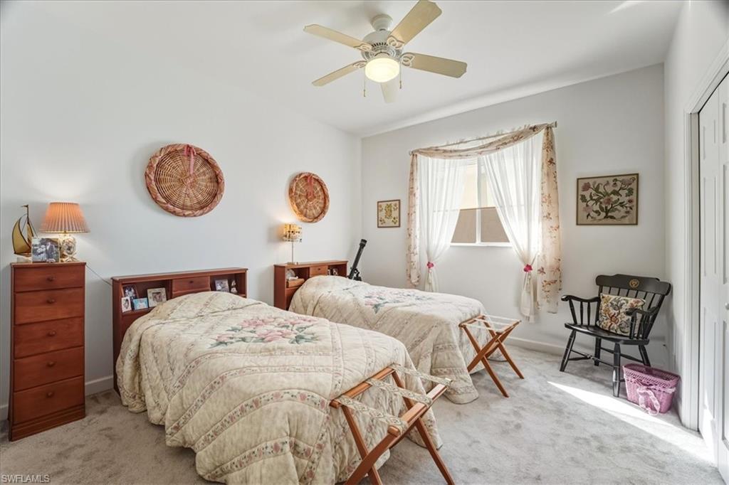 Bedroom with carpet floors, ceiling fan, and a closet