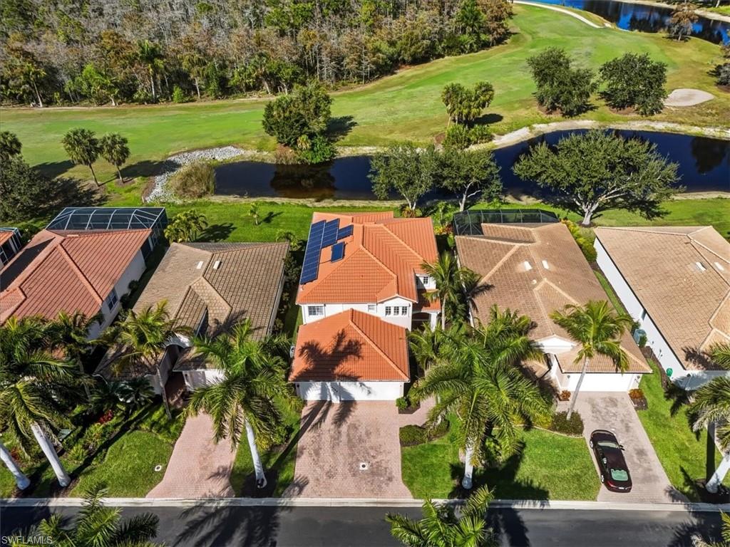 Aerial view of residential area with a large body of water and a golf course