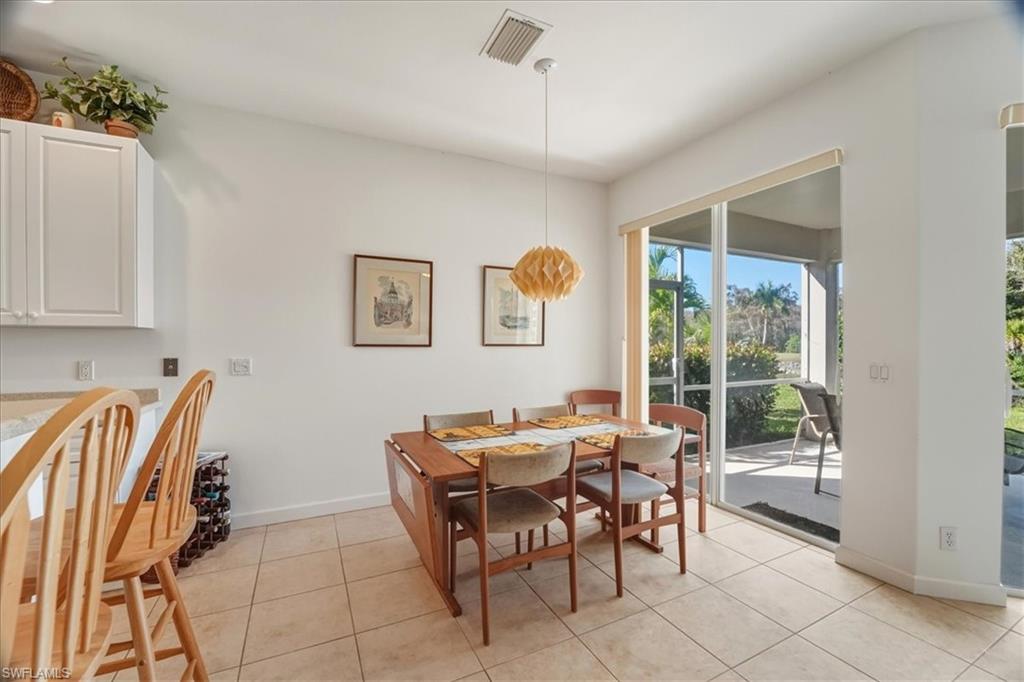 Dining space with light tile patterned floors and baseboards