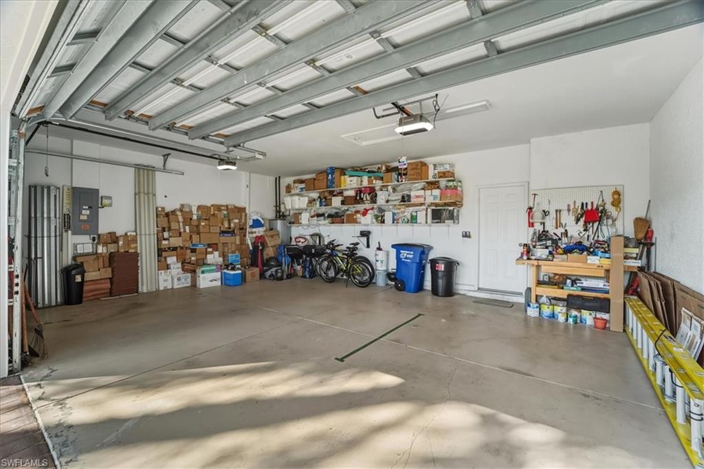 Garage with electric panel and a workshop area
