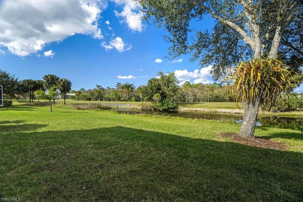 View of green lawn featuring a water view