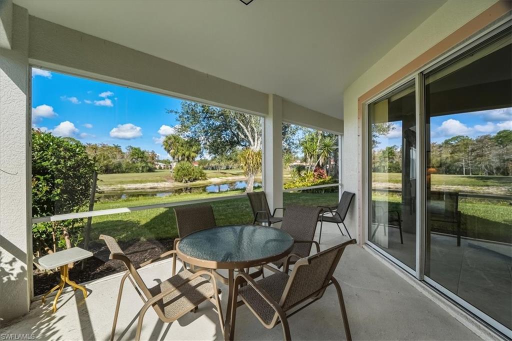 Sunroom with a water view and concrete floors