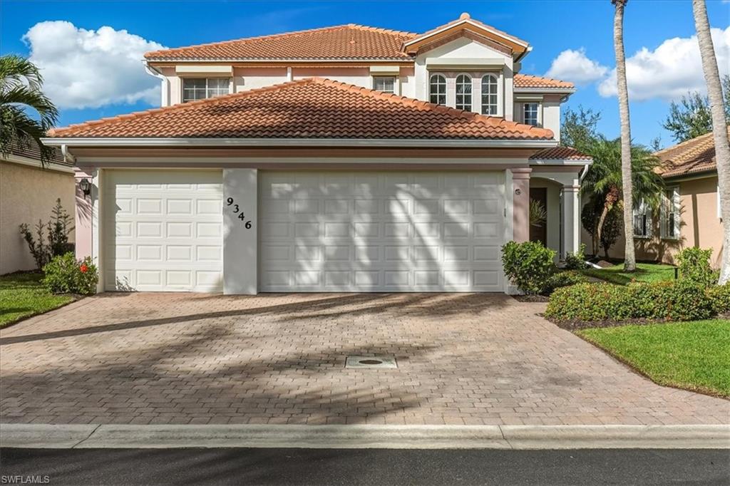 Mediterranean / spanish-style house featuring a tile roof, stucco siding, an attached garage, and driveway