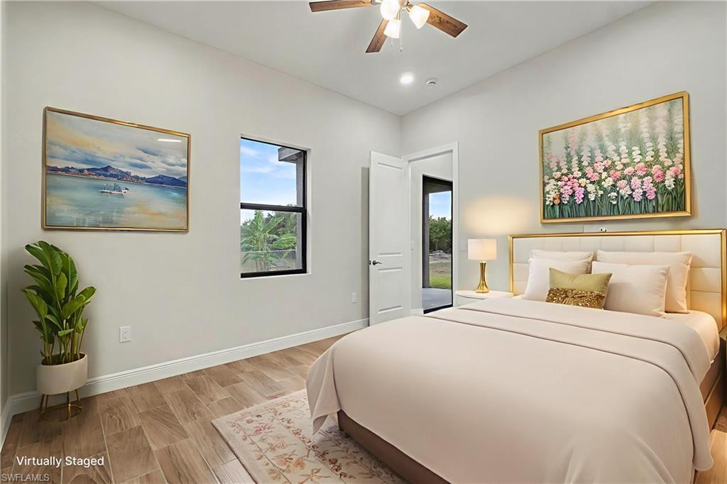 Bedroom with wood finish floors and ceiling fan